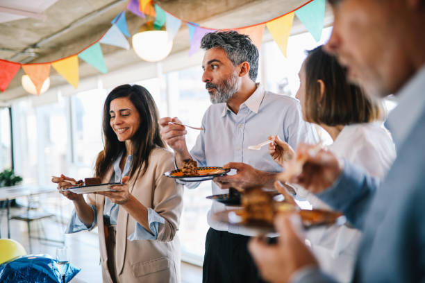 colleagues eating cake at the office birthday party - food stock pictures, royalty-free photos & images