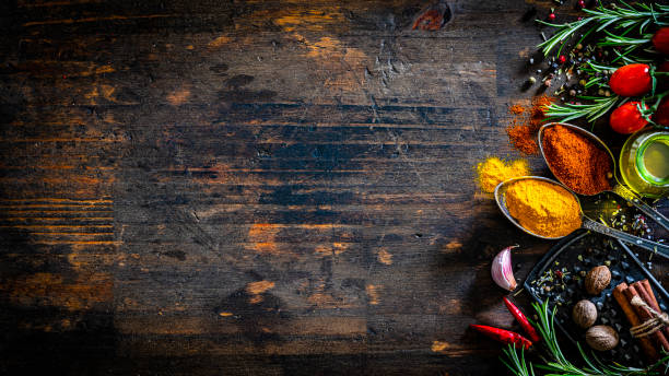 colored spices and herbs border on dark table - food stock pictures, royalty-free photos & images