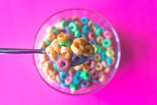 colorful breakfast cereal fills spoon - junk food stock pictures, royalty-free photos & images