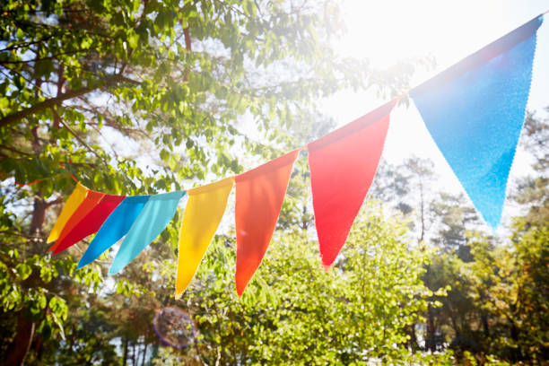 colorful bunting flags/ pennant chain for party decoration in garden - garden decoration stock pictures, royalty-free photos & images