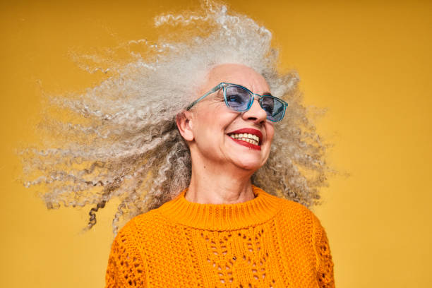 colourful studio portrait of a senior woman - hairstyle stockfoto's en -beelden