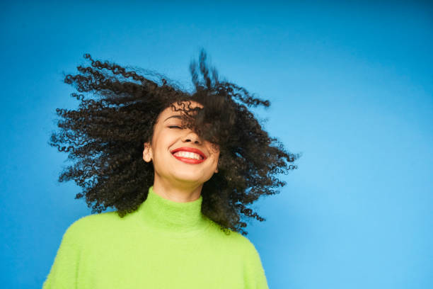 colourful studio portrait of a young woman dancing - hairstyle stockfoto's en -beelden
