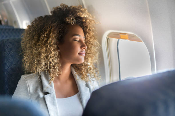commercial airline passenger sleeps in window seat - travel stock pictures, royalty-free photos & images