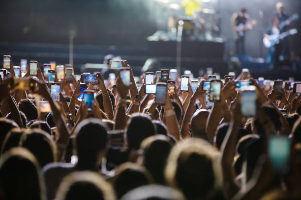 Concertgoers record videos and take photos with their smartphones as Jonas Brothers perform live on stage during a concert on April 16, 2024 in Sao...