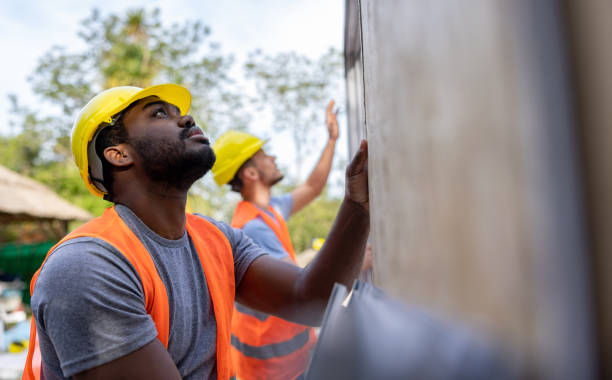 construction workers installing panels while building a manufactured house - home decoration stock pictures, royalty-free photos & images