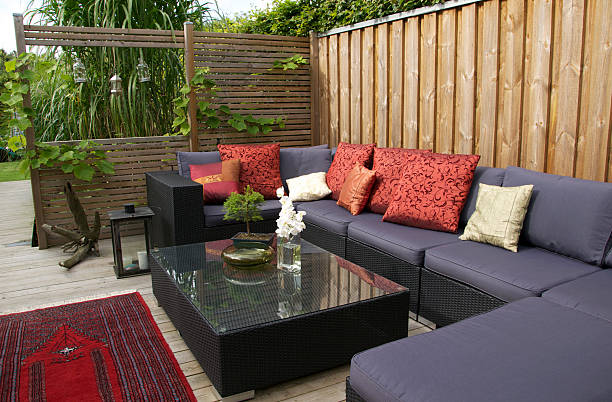 contemporary patio with large wicker sofa. garden design - home decoration stockfoto's en -beelden