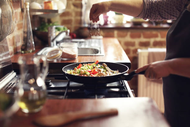 cooking vegetables, step seven, seasoning - food stock pictures, royalty-free photos & images
