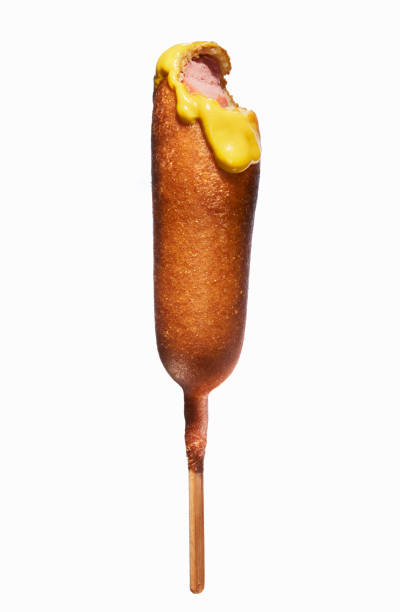 corn dog with mustard and bite out - junk food stock pictures, royalty-free photos & images