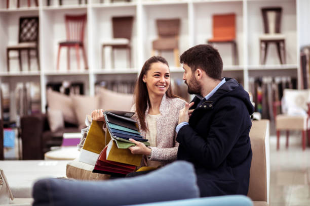 couple at a furniture store choosing fabrics - home decoration stock pictures, royalty-free photos & images