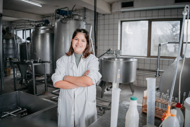 couple bottling milk on manufacture - food stock pictures, royalty-free photos & images