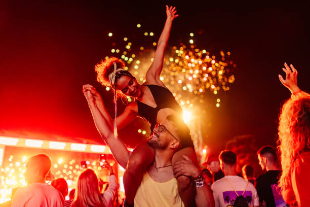 couple celebrating with fireworks - concert stock pictures, royalty-free photos & images