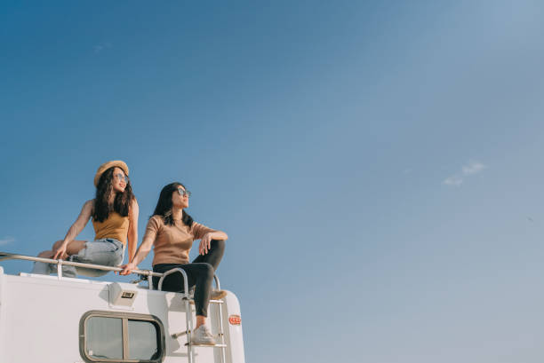 couple de lesbiennes chinoises asiatiques profitant d’une vue panoramique sur le toit d’un camping-car en plein air pendant la matinée du week-end - travel photos et images de collection