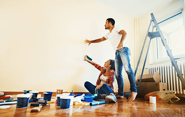 couple decoration their apartment. - home decoration stockfoto's en -beelden