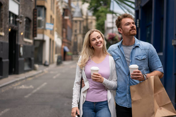couple doing some shopping and drinking coffee - junk food stock pictures, royalty-free photos & images