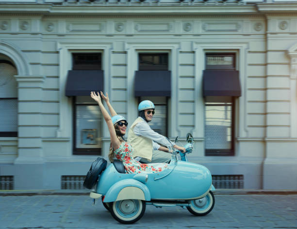 couple driving vintage scooter and sidecar - travel stockfoto's en -beelden