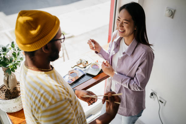 couple eating sushi - junk food stock pictures, royalty-free photos & images