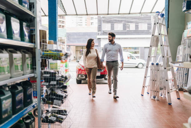 couple entering a construction material store - home decoration stock pictures, royalty-free photos & images