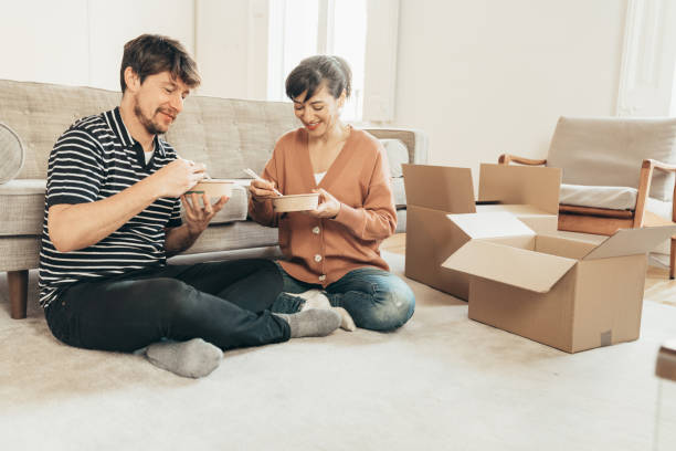 couple having lunch at home during quarantine - junk food stock pictures, royalty-free photos & images