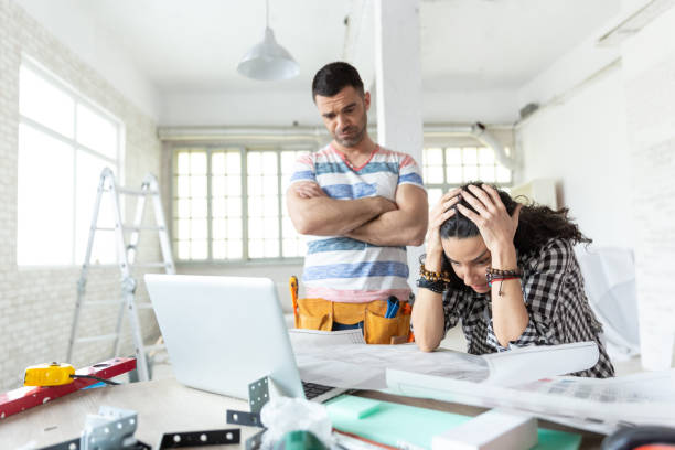 couple having problems during home renovations - home decoration stock pictures, royalty-free photos & images