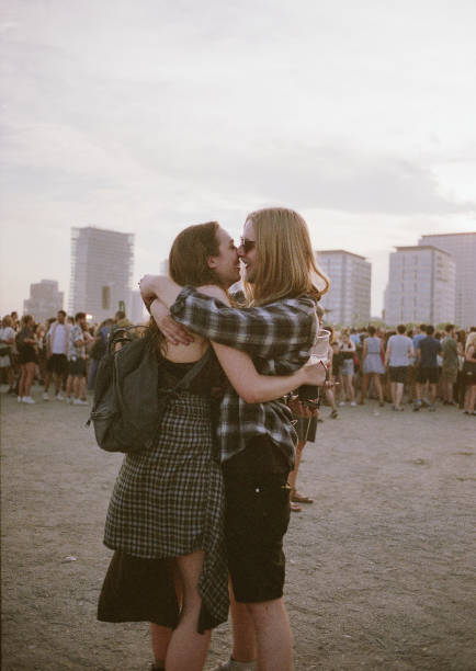 couple kissing at a festival - concert stock pictures, royalty-free photos & images