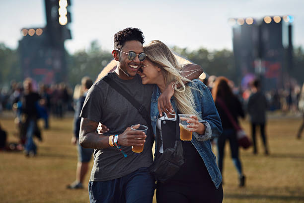 couple laughing together at concert - concert stock pictures, royalty-free photos & images