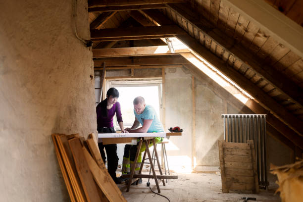 couple making plans to renovate old attic - home decoration stock pictures, royalty-free photos & images