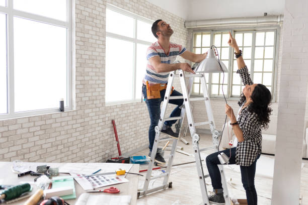 couple making renovations, changing lighting equipment - home decoration stock pictures, royalty-free photos & images