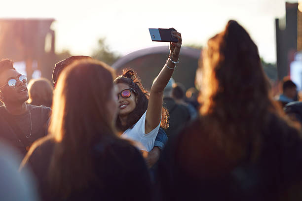 couple making selfie at big festival concert - concert stock pictures, royalty-free photos & images