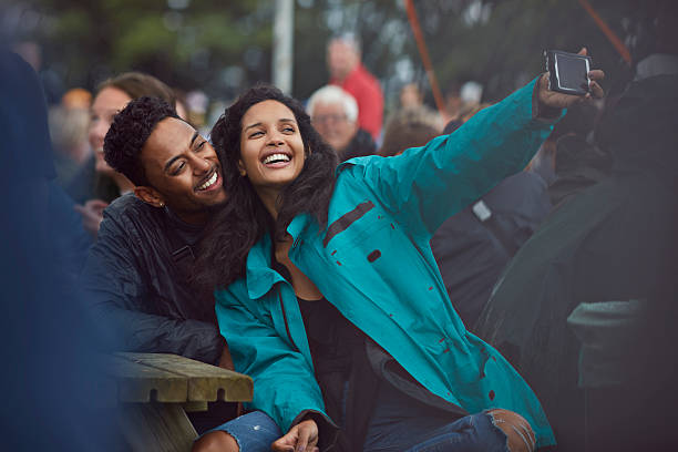 couple making selfie at festival - concert stockfoto's en -beelden