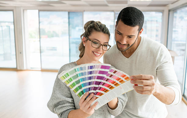 couple painting their house - home decoration stock pictures, royalty-free photos & images