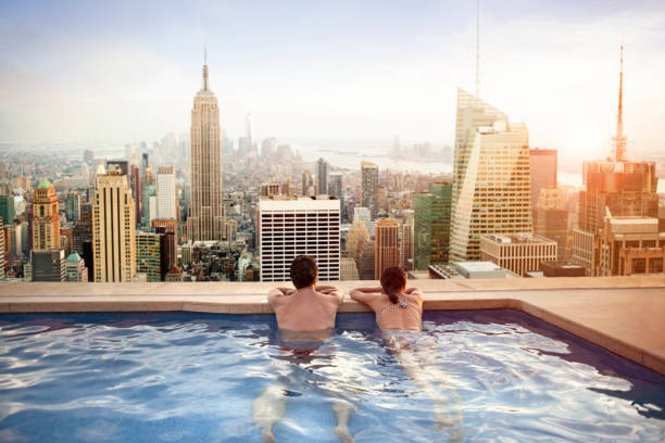couple relaxing on hotel rooftop - travel stock pictures, royalty-free photos & images