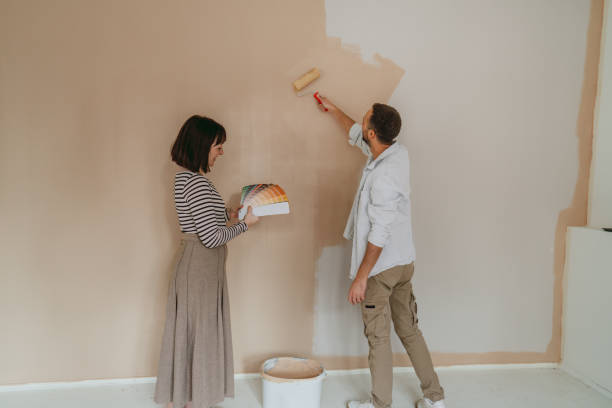 couple renovating and choosing paint colors for their home - home decoration stock pictures, royalty-free photos & images