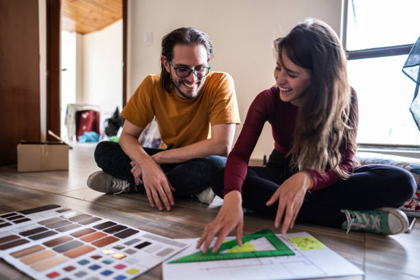 couple talking while making decisions about the new apartment - home decoration stock pictures, royalty-free photos & images