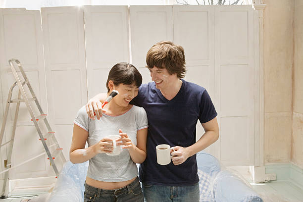 couple with paint smears drinking coffee - home decoration stock pictures, royalty-free photos & images