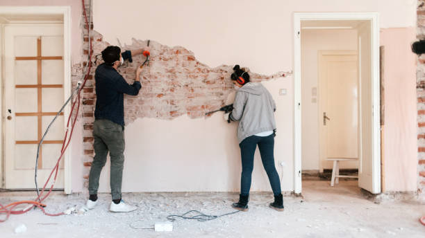 couple working on reconstruction of their apartment - home decoration stock pictures, royalty-free photos & images