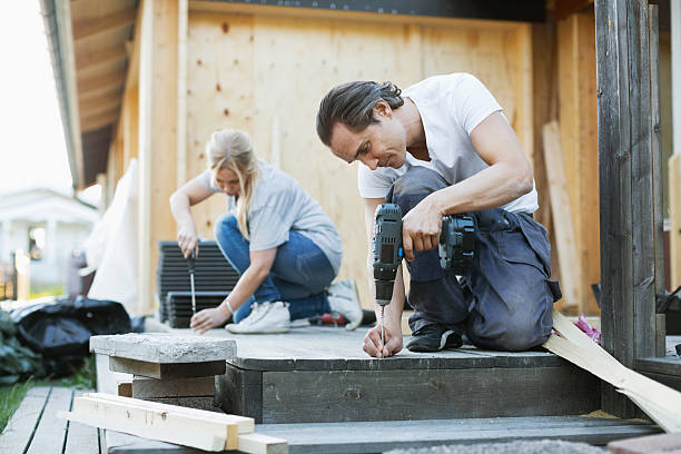 couple working outside house during home improvement - home decoration stock pictures, royalty-free photos & images