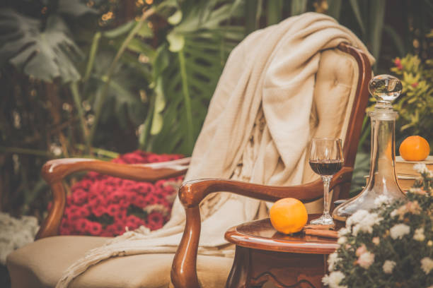 cozy armchair, warm blanket and red wine - garden decoration stock pictures, royalty-free photos & images