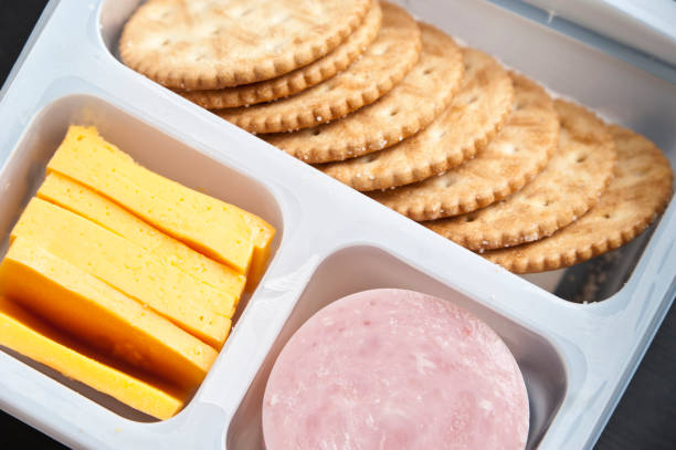 crackers, sliced cheese and ham in a plastic tray - junk food stock pictures, royalty-free photos & images