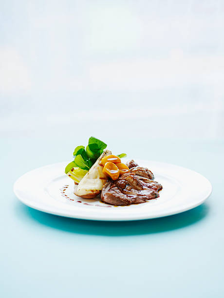 crisp liberty duck breast, braised endive, watercress and grilled pears. - food stock pictures, royalty-free photos & images