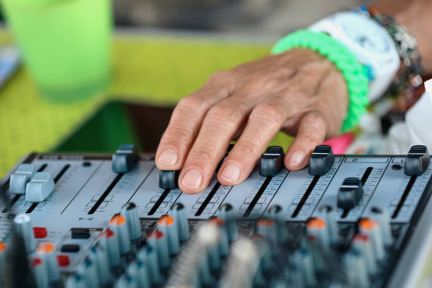 cropped hands senior woman working with sound mixer and doing dj set for outdoor summer party - concert stock pictures, royalty-free photos & images