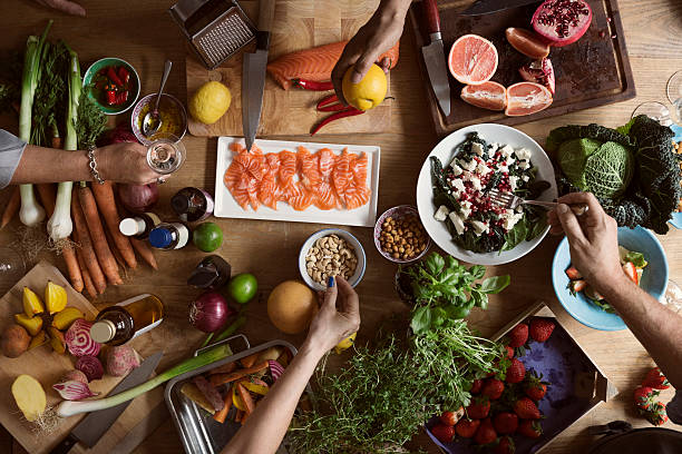 cropped image of hands preparing food on table - food stock pictures, royalty-free photos & images