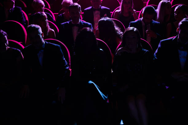 crowd in dark watching opera in theater - concert stock pictures, royalty-free photos & images