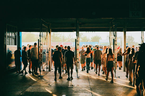 crowd of people entering music festival - concert stock pictures, royalty-free photos & images