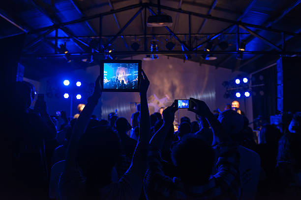 crowd using tablet pc at rock concert - concert stock pictures, royalty-free photos & images