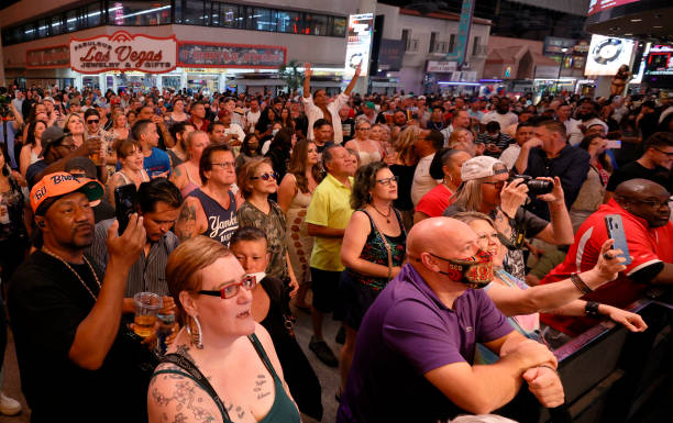 Crowd watches musical act Zowie Bowie in concert during a "Downtown Rocks Again!" event at the Fremont Street Experience on June 1, 2021 in Las...