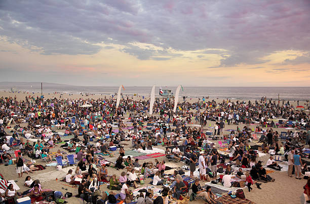 crowds gathered on the beach for outdoor concert - concert stock pictures, royalty-free photos & images