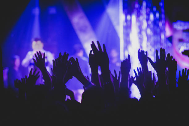 crown rising hand in concert - concert stock pictures, royalty-free photos & images