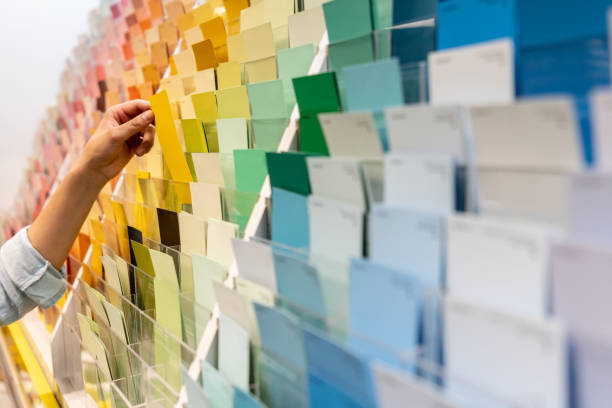 customer holding a color sample at a home improvement store - home decoration stock pictures, royalty-free photos & images