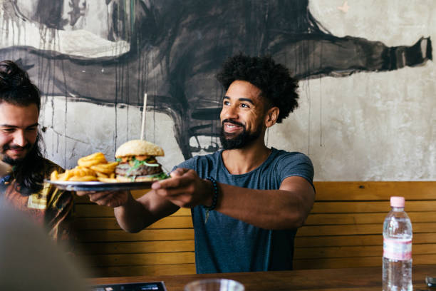 customer receiving food at burger restaurant - food stockfoto's en -beelden