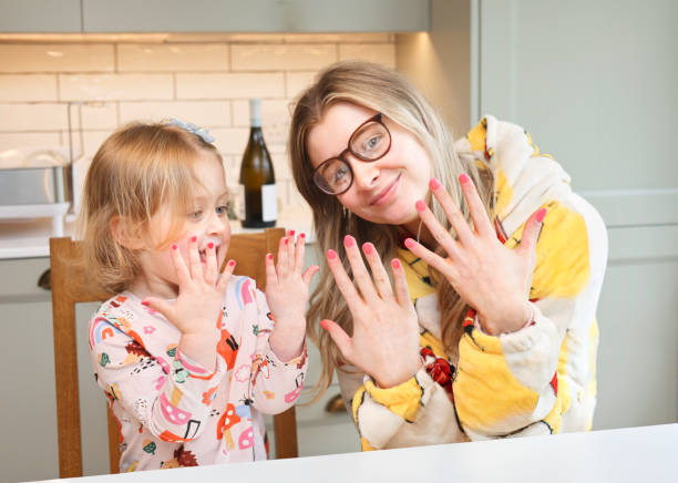 cute 3 year and her cool auntie showing off their newly nails. - nails art stock pictures, royalty-free photos & images